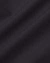 Black Commuter Long Sleeve Shirt's smooth, dark fabric with fine weave.