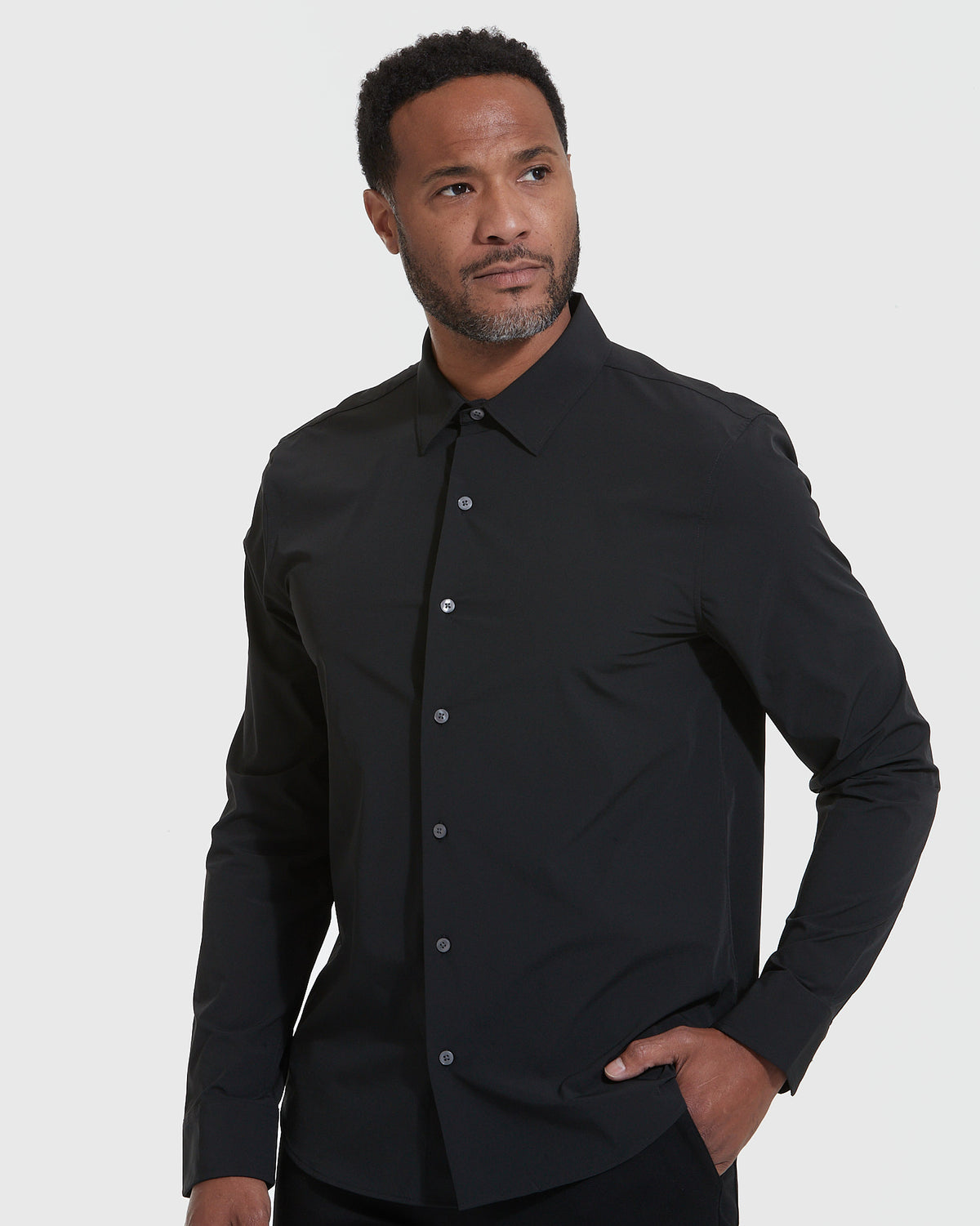 Black Lightweight Dress Shirt on man, hand in pocket, gray background.