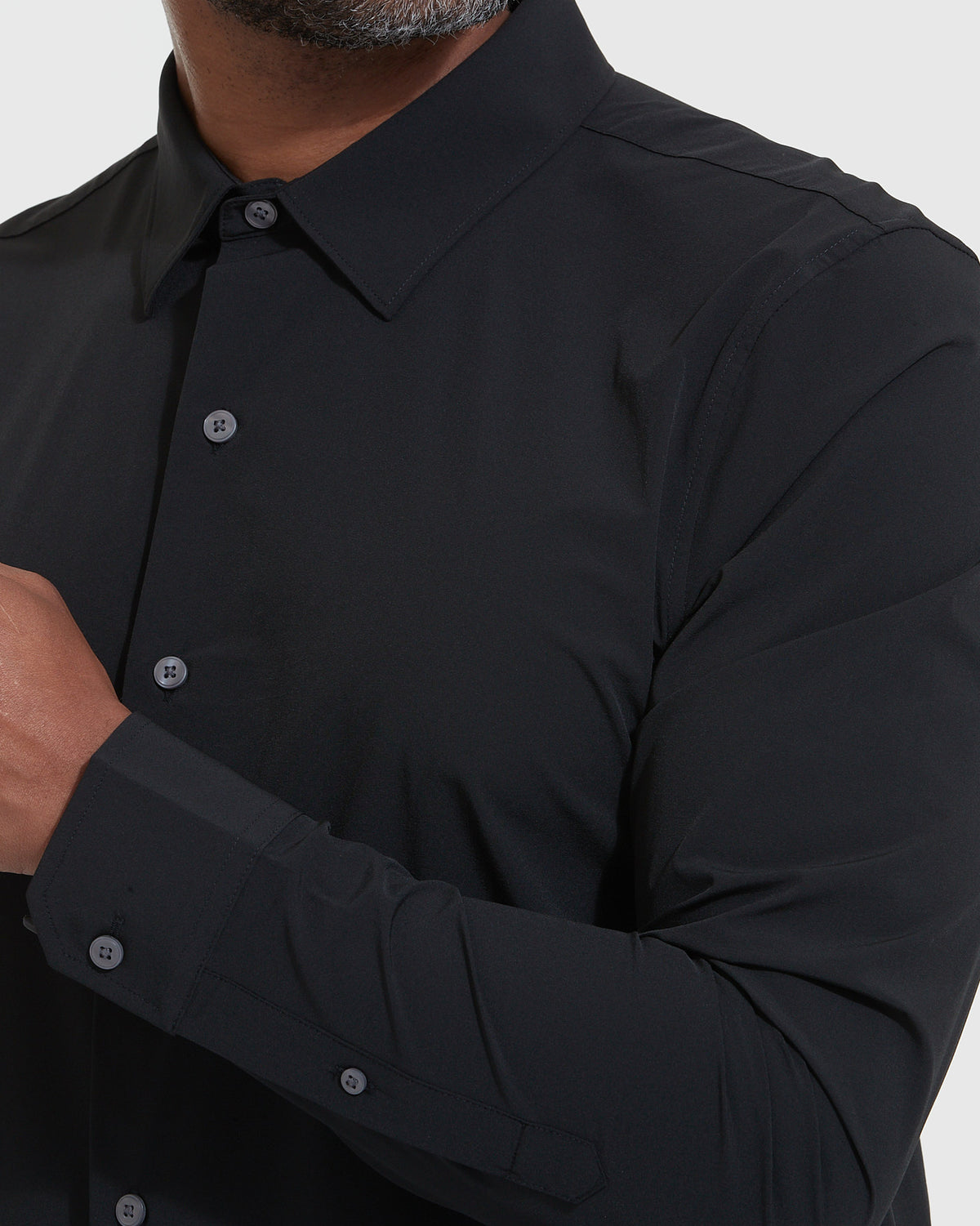 Black Lightweight Dress Shirt with collar, buttons, and cuffed sleeve visible.