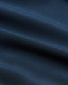 Close-up view of smooth navy fabric texture used in the Navy Performance Long Sleeve Dress Shirt, highlighting its refined weave and rich color for men's basics.