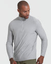 Man wearing Light Heather Gray Active Quarter Zip Shirt, looking down.