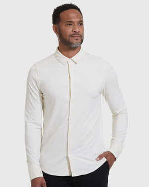 Man wearing Ecru Long Sleeve Do-It-All Comfort Shirt against gray background.