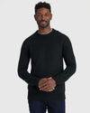 Black Crew Neck Sweater worn by man with short curly hair.