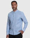 Banker Blue Stretch Oxford Long Sleeve Shirt worn by a casually posed model.