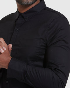 True ClassicBlack Stretch Oxford Long Sleeve Shirt on man with clasped hands.