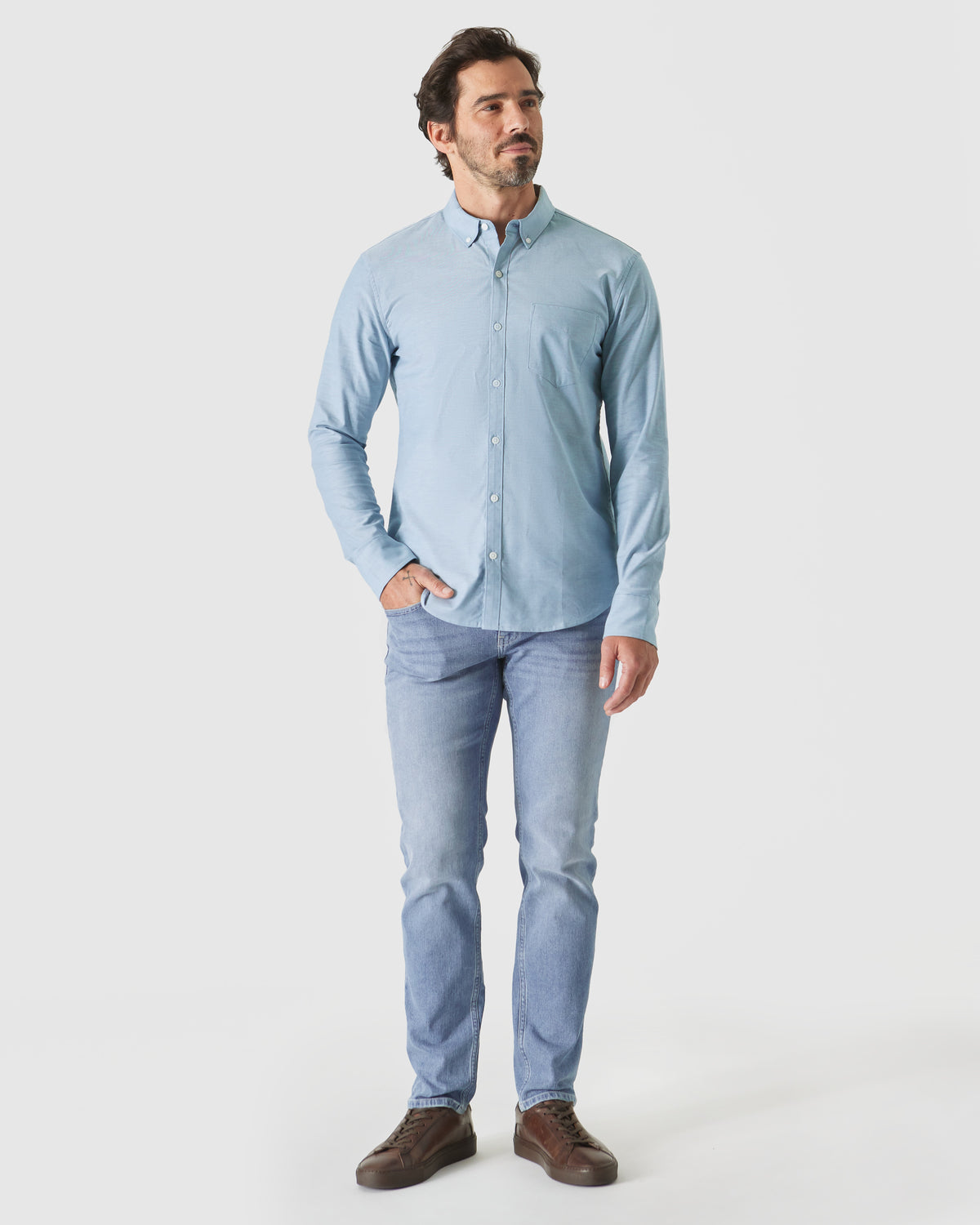 Man wearing Harbor Stretch Oxford Long Sleeve Shirt with jeans and sneakers.