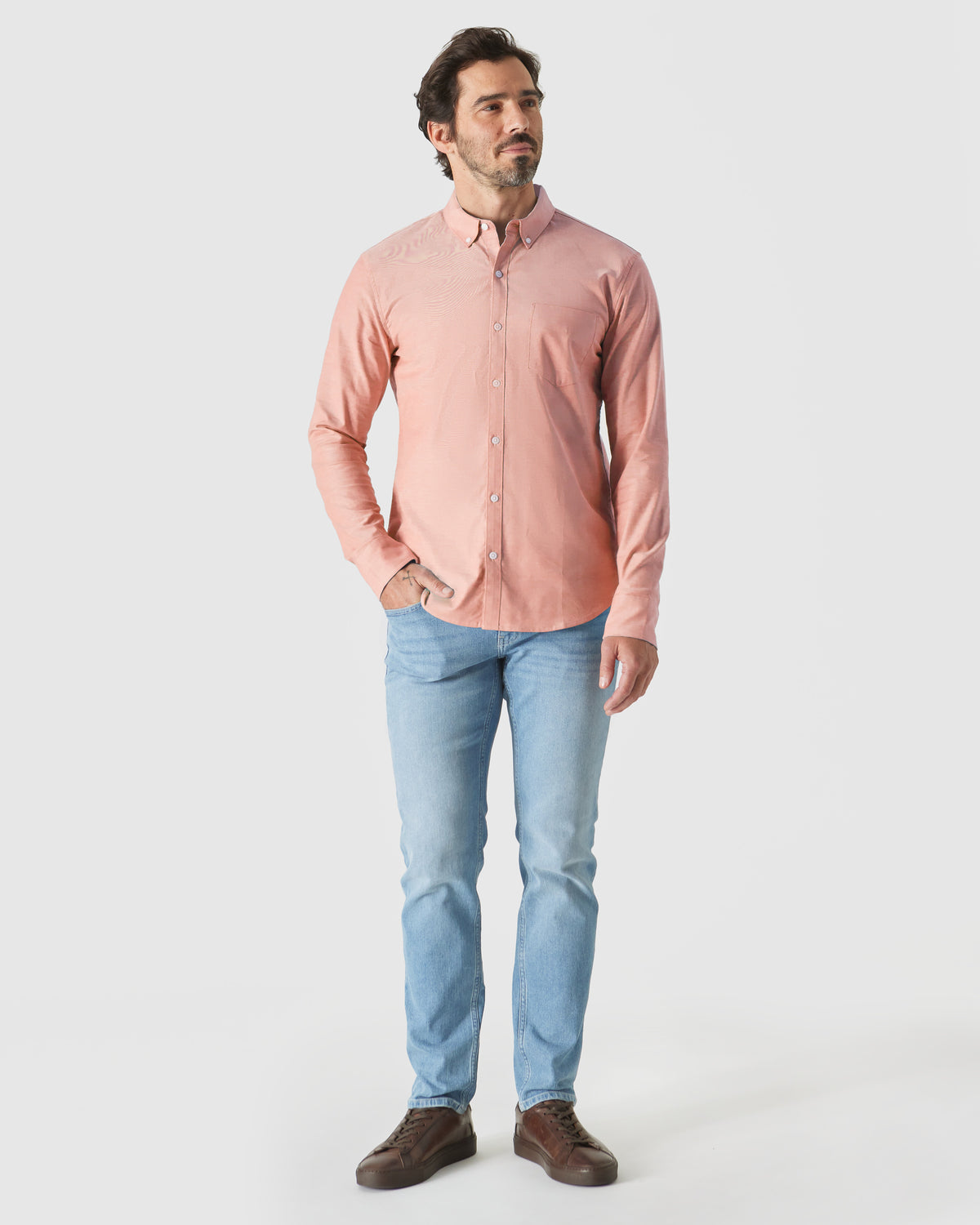 Model wearing Peach Long Sleeve Oxford Shirt with jeans and sneakers.