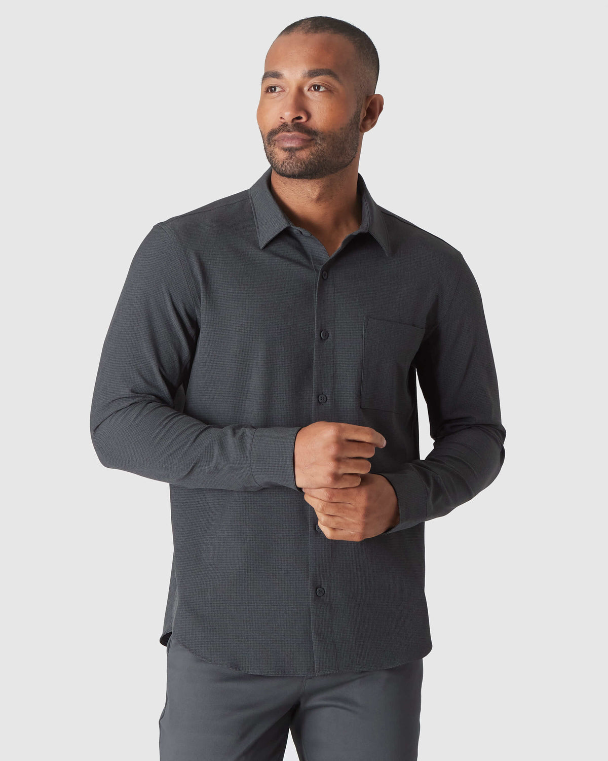 Man wearing Charcoal Heather Gray Long Sleeve Ripstop Commuter Shirt.