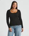 Woman wearing a black long-sleeve top and blue jeans on a light gray . MODEL_INFO: Jade is 5'9", wearing a size Lbackground