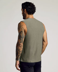 True ClassicA man with tattoos on his left arm wearing a Heather Military Green Sleeveless Active Muscle Tee, shown from the back, highlighting the fitted sleeveless design and soft fabric.