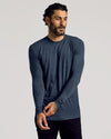 Man wearing Heather Navy Tall Long Sleeve T-Shirt adjusting sleeve.