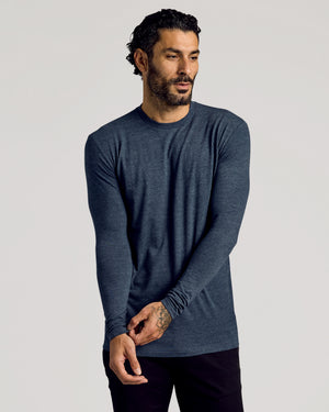 Man wearing Heather Navy Tall Long Sleeve T-Shirt adjusting sleeve.
