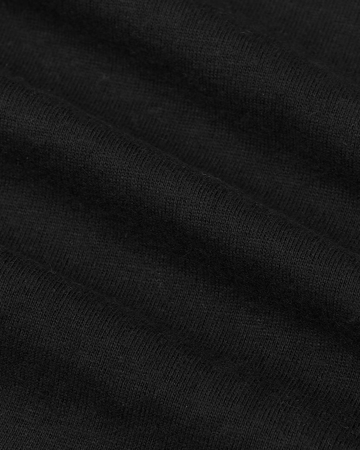 Black knit fabric close-up of the All Black Tall Classic Polo.
