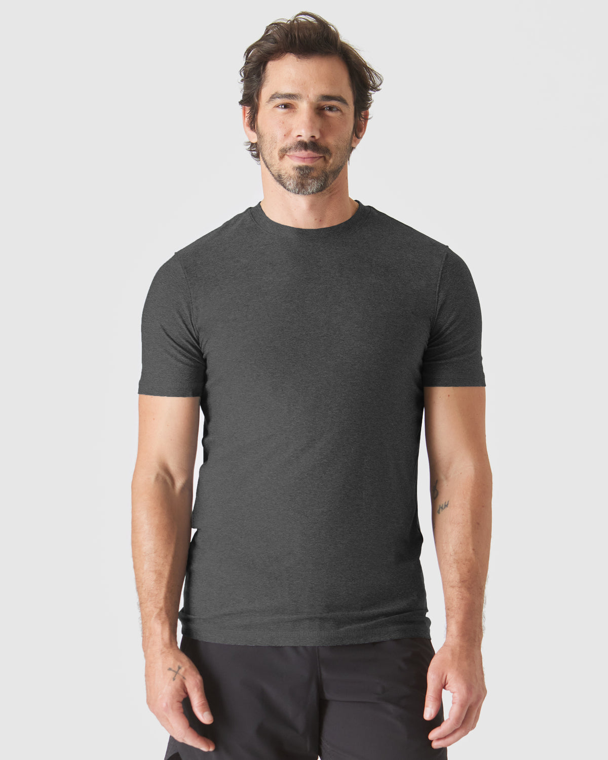 Man wearing Staple Tall Active Crew T-shirt, showcasing casual fit.