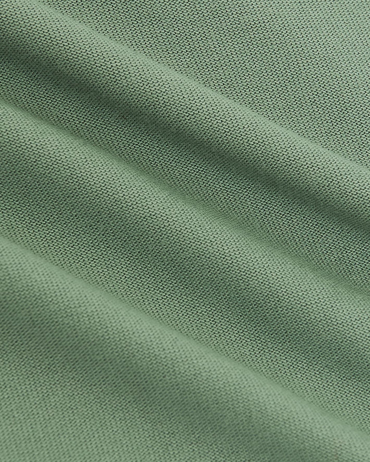 Close-up view of soft sage green fabric texture from the Sage Green Tall Active Crew Neck, highlighting the fine knit detail of this men's basics essential.