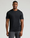 Man wearing a fitted black crew neck t-shirt paired with dark pants, showcasing the Tall Pima Cotton Blend Crew 4-Pack men's basics in a clean, classic style.