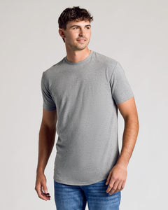 True ClassicTall man wearing Short Sleeve Tall Curved Hem Crew, gray T-shirt, blue jeans.