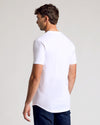 Man wearing All White Short Sleeve Tall Curved Hem Crew, viewed from behind.