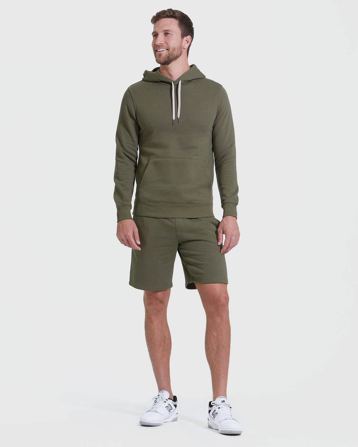 Man wearing Military Green Fleece French Terry Pullover Hoodie and shorts.