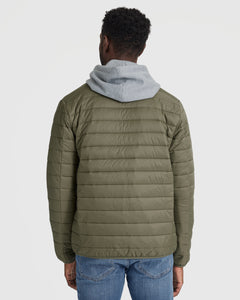 True ClassicMan wearing Military Green Puffer Jacket, gray hoodie, blue jeans.