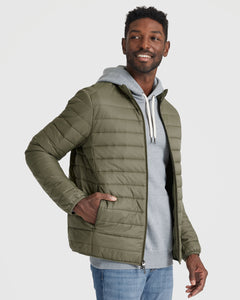 True ClassicMan wearing Military Green Puffer Jacket, smiling, hand in pocket.