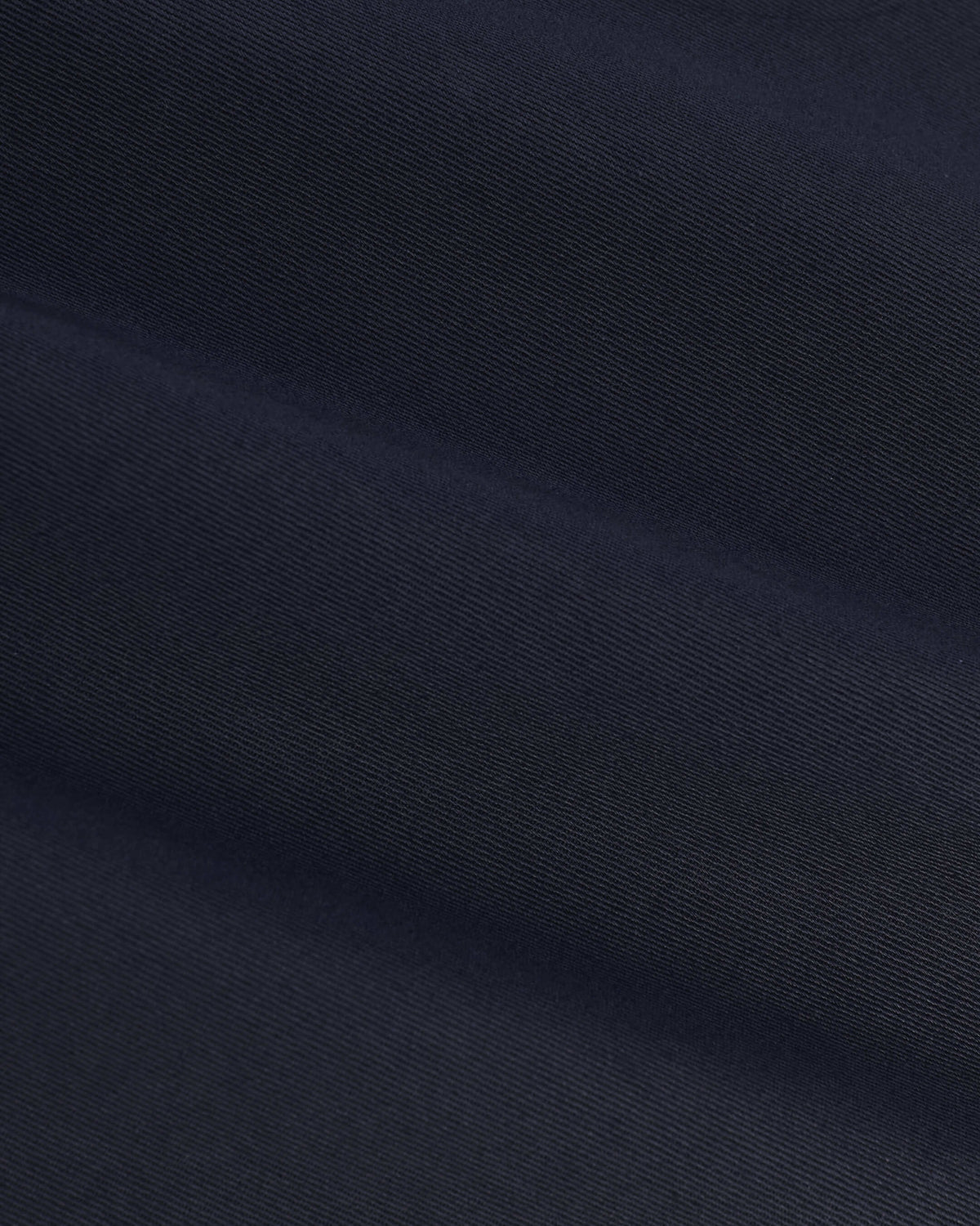 Navy Coaches Jacket's fine diagonal twill pattern, showcasing soft folds.