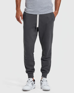True ClassicCarbon Fleece French Terry Joggers with sneakers and a T-shirt.