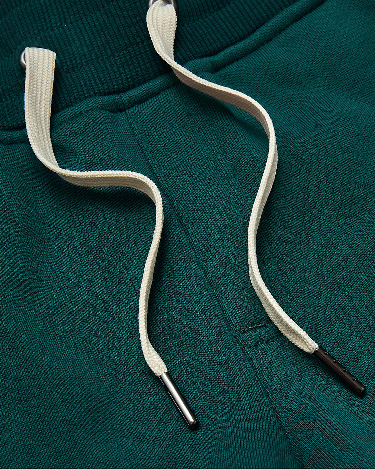 Deep Emerald Jogger close-up: waistband, pocket, off-white drawcords.