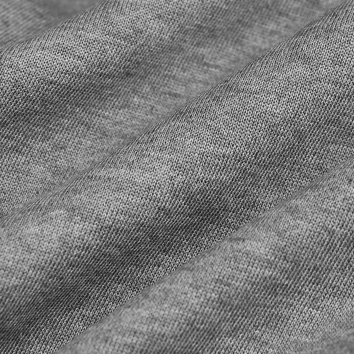Close-up texture of soft heather gray fabric used in Heather Gray Fleece French Terry Joggers, highlighting the knit and cozy material ideal for men's basics.