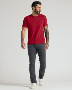 True ClassicMan wearing Gray Wash Straight Comfort Stretch Jeans, red t-shirt, off-white sneakers.