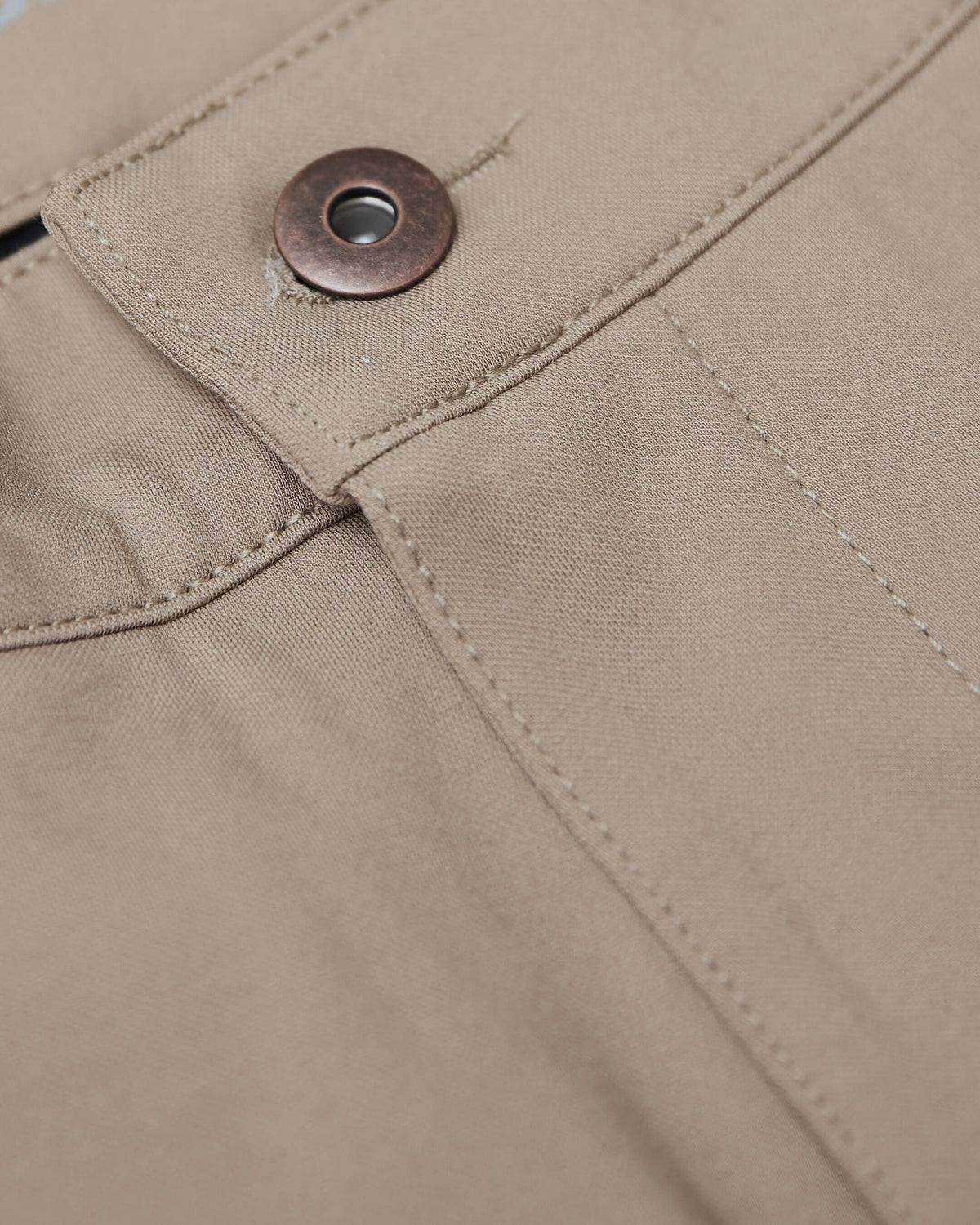 Khaki Commuter Pants' waistband and pocket with metal snap button.