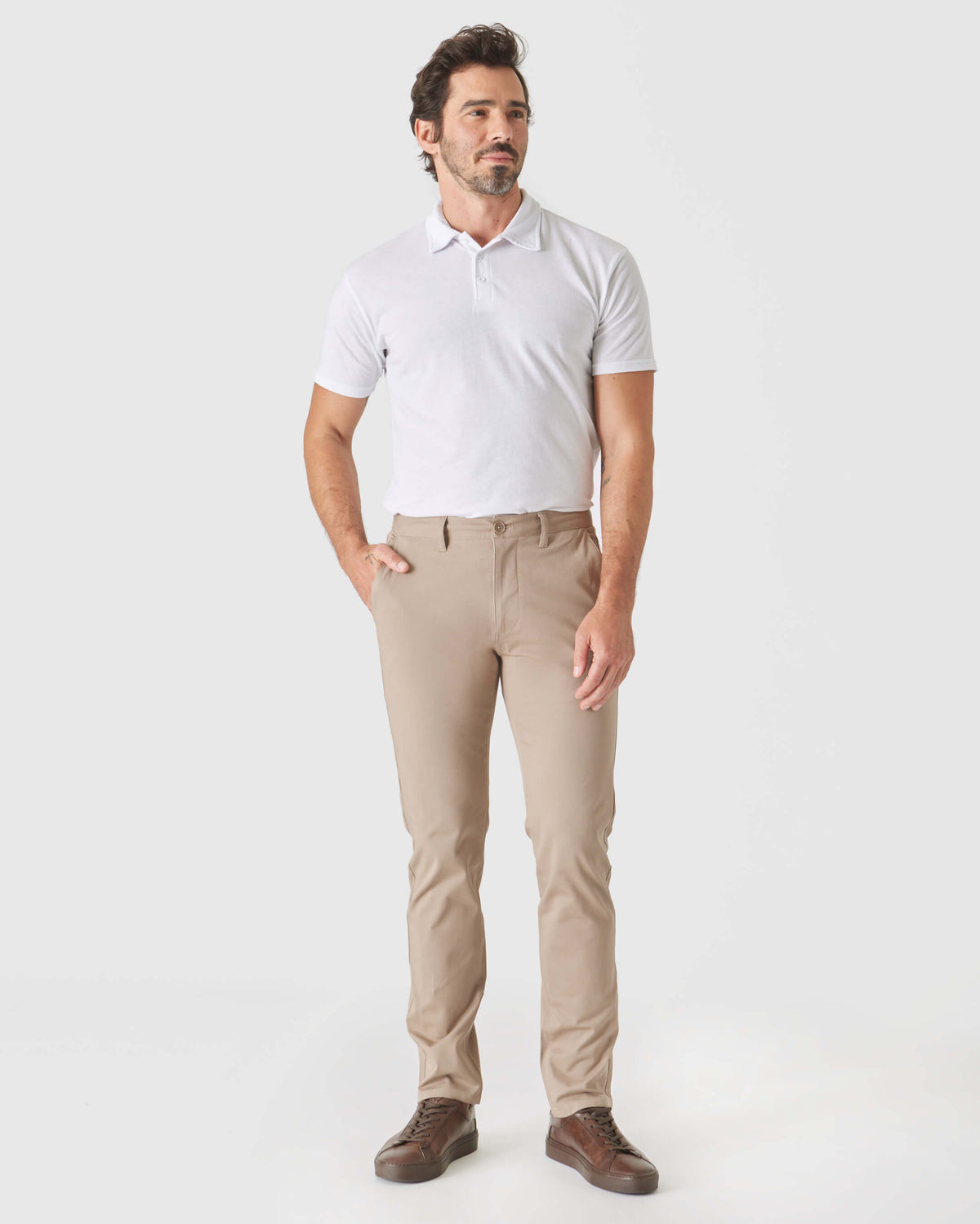 Man wearing Khaki Slim Twill Chino Pant with white polo and brown shoes.