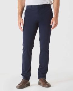True ClassicNavy Slim Twill Chino Pant with brown leather sneakers.