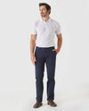 Man wearing Khaki & Navy Straight Twill Chino with a white polo.