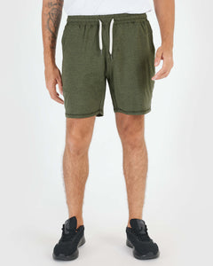 True ClassicDark Heather Military Green Active Comfort Short with black sneakers.