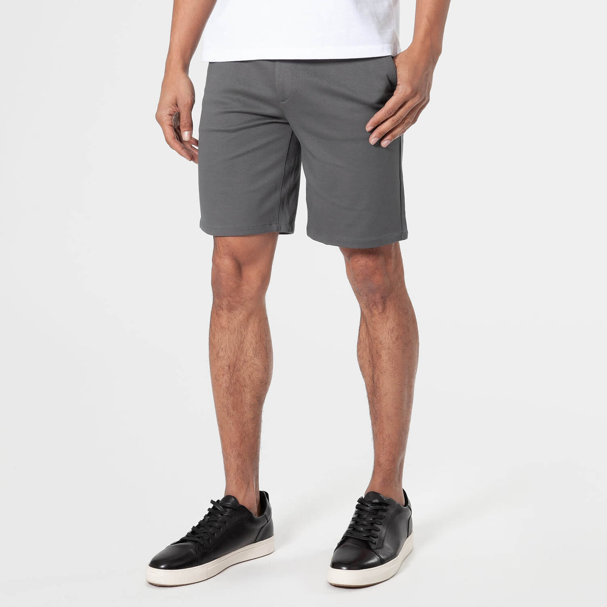 Carbon Comfort Chino Short with black sneakers on a person.
