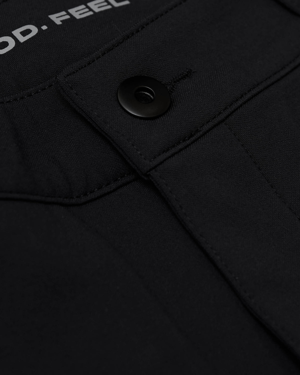 Black Commuter Short close-up showing flap pocket with snap button.