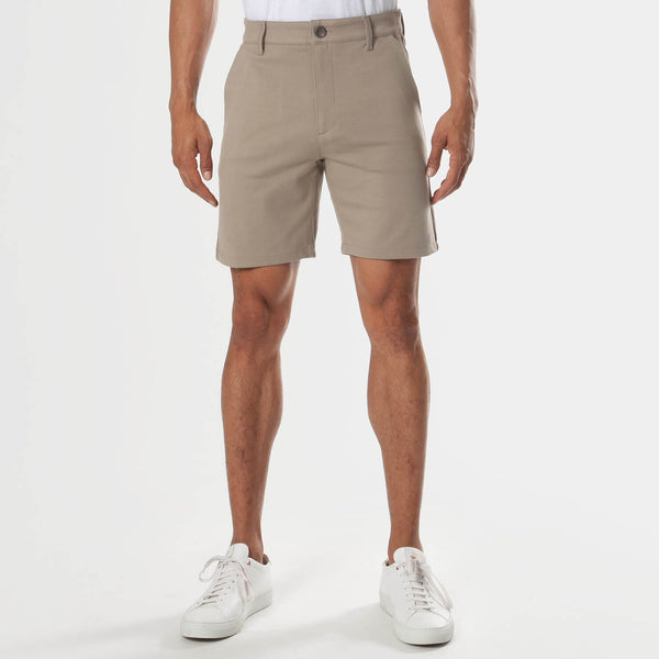7 Khaki Comfort Knit Chino Shorts worn with white sneakers.
