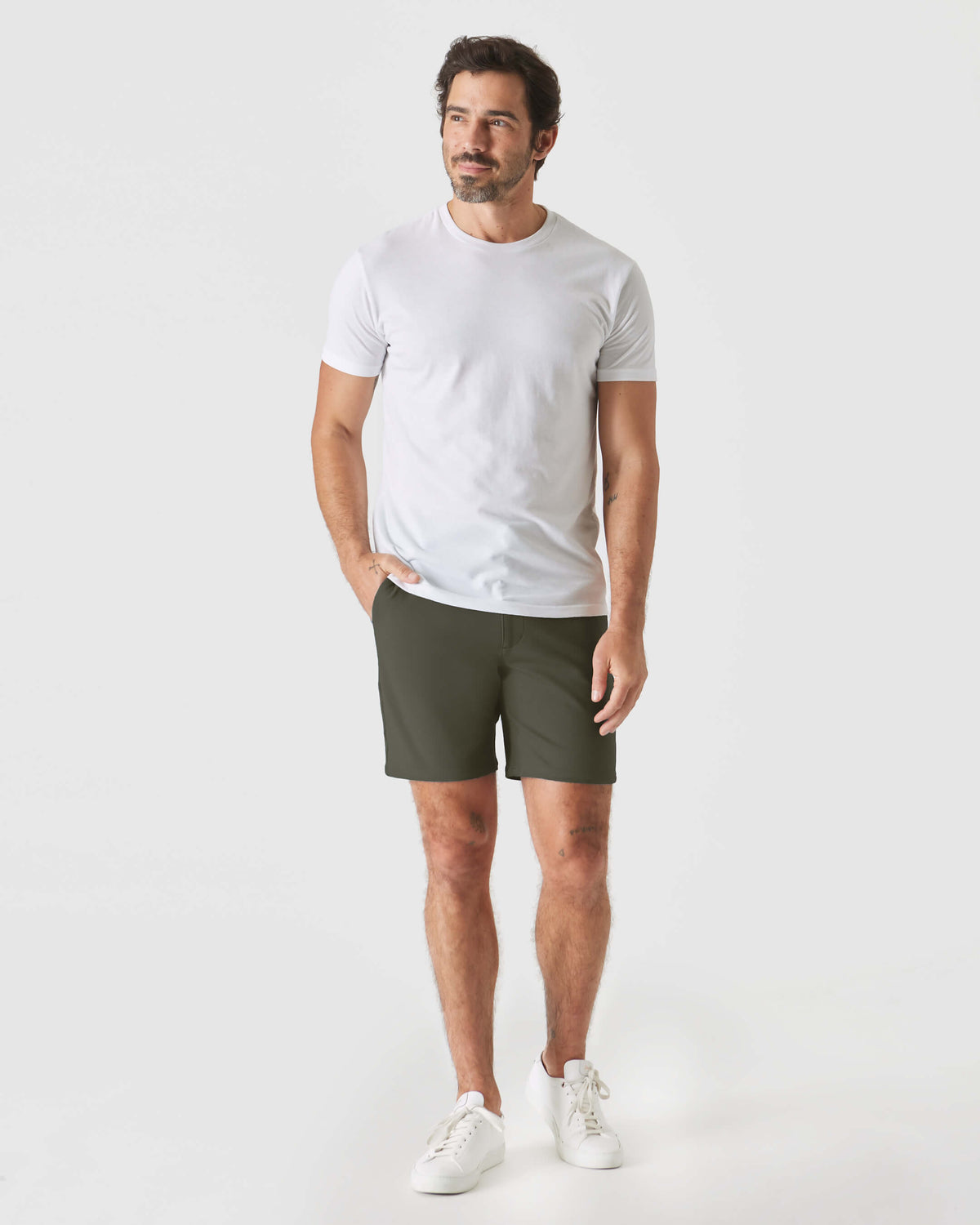 Man wearing 7 Military Green Comfort Knit Chino Short with tattoos visible.