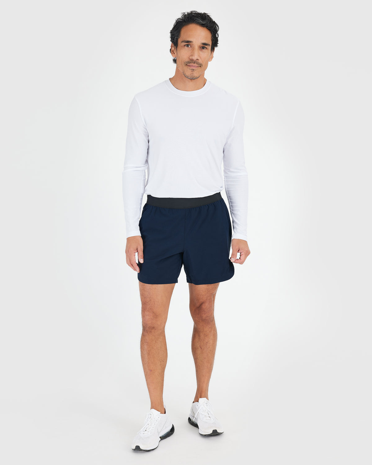 7 Navy Active Training Shorts 2.0 with black waistband and zippered pockets.