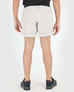 True Classic7 Sandstone Active Training Short, mid-thigh length, perforated hems, zip pocket.