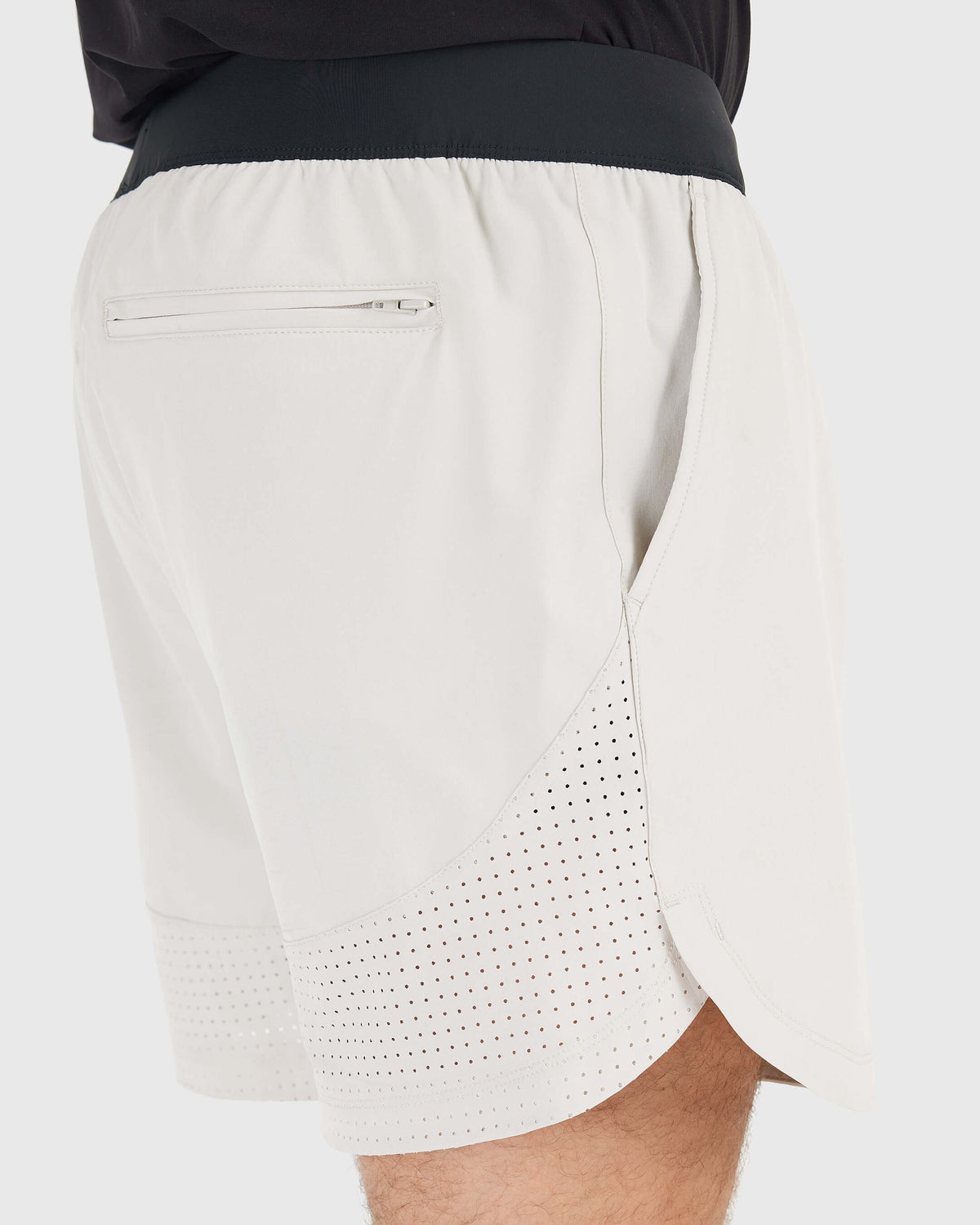 7 Sandstone Active Training Short with black waistband, zippered pocket, and ventilated hem.
