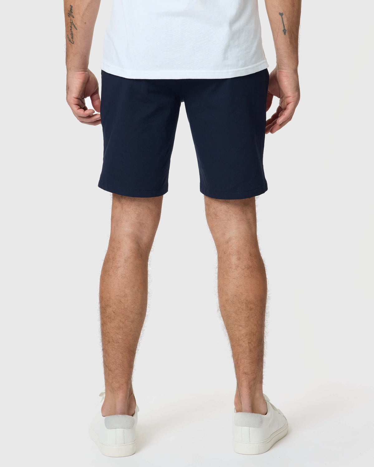 Navy Twill Short styled with white sneakers and visible tattoos.