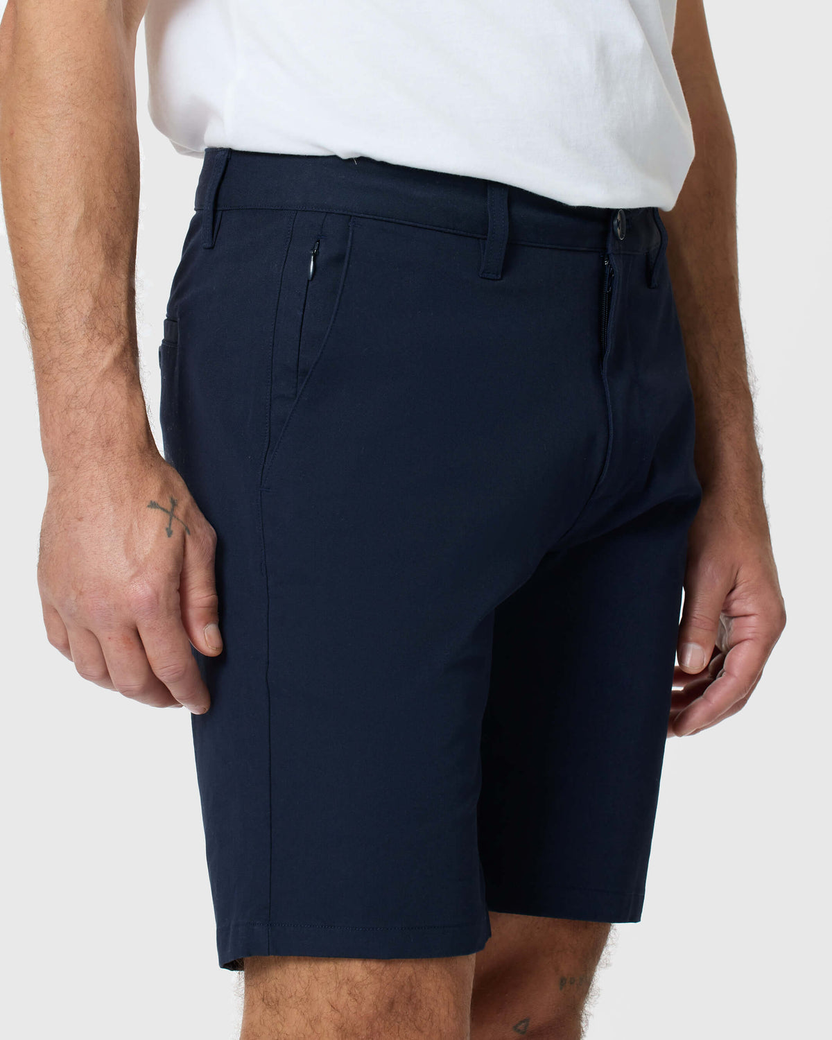 Man wearing Navy Twill Short with tattooed legs visible.
