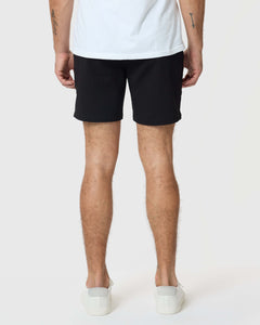 True Classic7 Black Classic Twill Shorts, worn with white sneakers, hem visible.