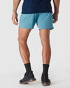 Voyager 7 2-in-1 Training Shorts with black shoes visible.
