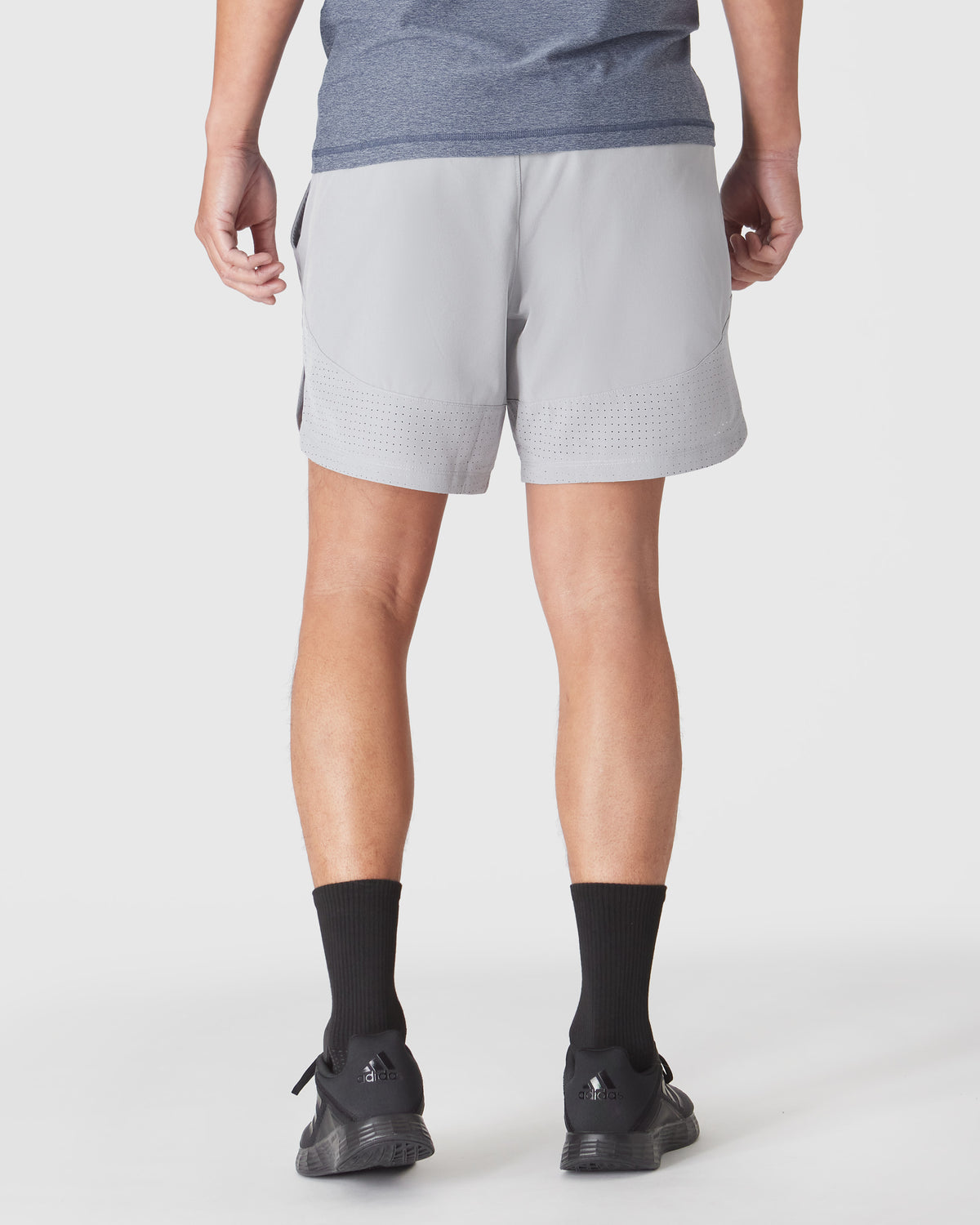 Steel 7 Active Training Short with perforated hem, worn with Adidas shoes.