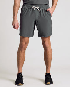 True ClassicCarbon 9 Active Quick Dry Shorts modeled with black sneakers.