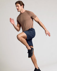 True ClassicMan wearing Navy 9 Active Quick Dry Shorts, performing a high-knee drill.