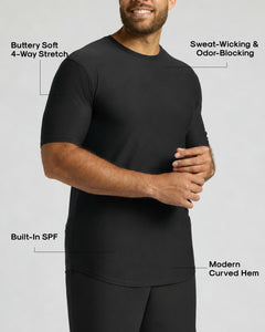 True ClassicA man wearing a black short-sleeve athletic shirt with text callouts highlighting features such as buttery soft 4-way stretch, sweat-wicking and odor-blocking, built-in SPF, and modern curved hem.